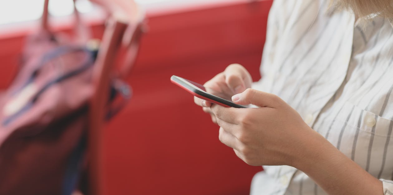 Photo Of Person Using Smartphone